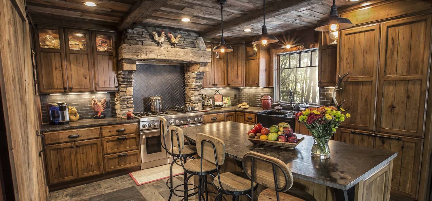 Rustic kitchen featuring natural wood cabinetry, stonework, and a large island